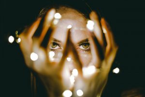 woman joyfully holding lights in her hand
